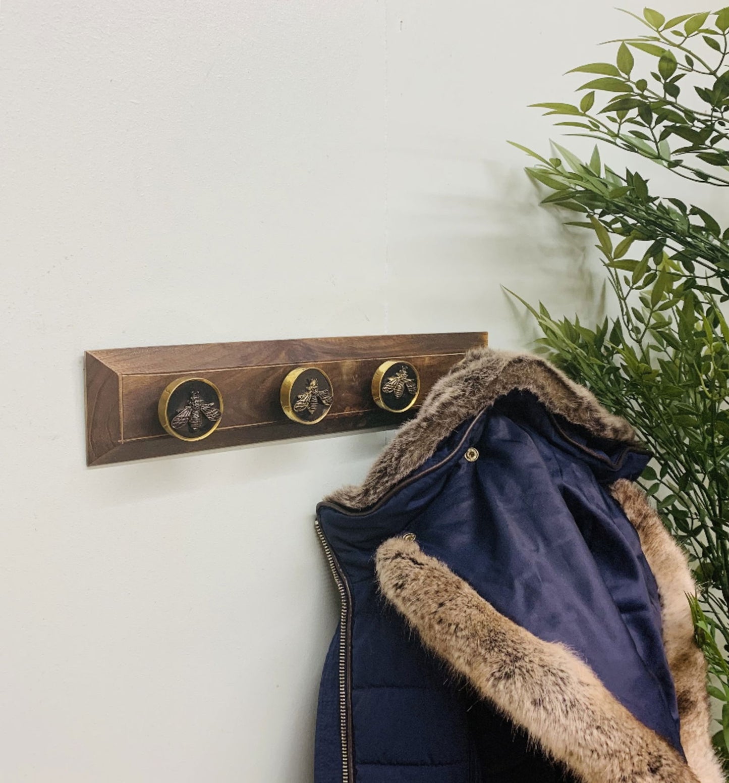 Four Bee Design Coat Knobs On A Wooden Base